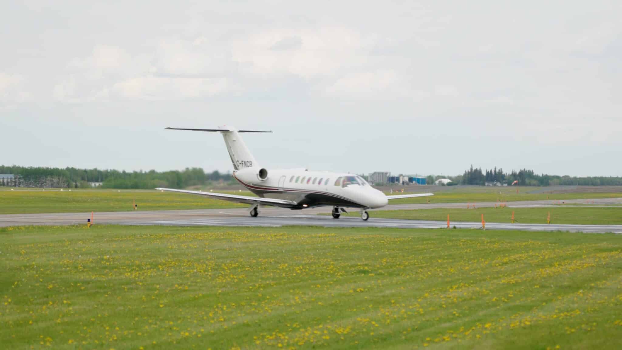 Private jet on runway, ready for takeoff.